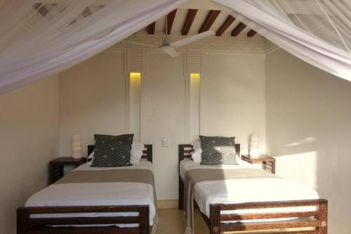 Ένα ή περισσότερα κρεβάτια σε δωμάτιο στο Peponi Hotel Lamu - Kenya