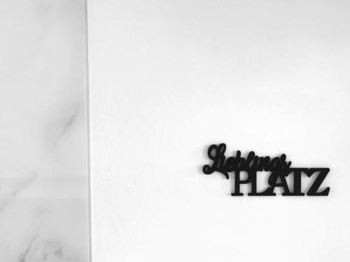 a sign that says blizzard pizza on a white wall at Lieblingsplatz Neusiedl Appartement - Erhol dich gut in Neusiedl am See