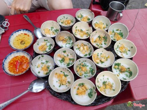 a table topped with bowls of food on a table at Coconut Hotel Phú Yên in Tuy Hoa
