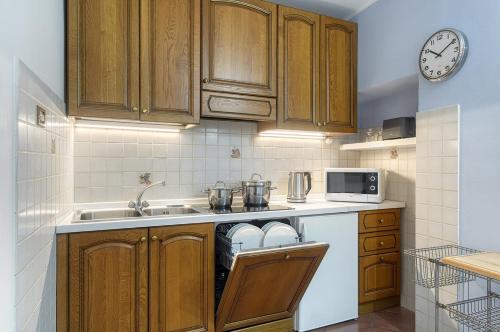 a kitchen with wooden cabinets and a sink at Casa Dany in Malcesine