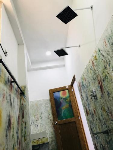 a room with a door and a painting on the wall at The Hobbit Cottage-Ella in Ella
