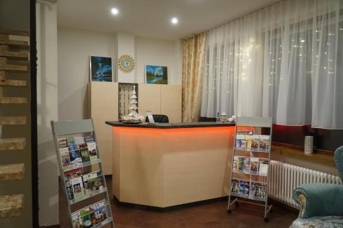 a bar in a room with a window and shelves at Hotel Eleon in Bad Teinach-Zavelstein