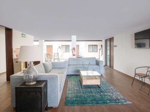 a living room with a couch and a table at Fraga Hotel Boutique in Irapuato