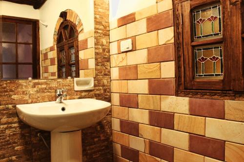 a bathroom with a sink and a mirror at Patio de Piedra Hotel Boutique in La Paz