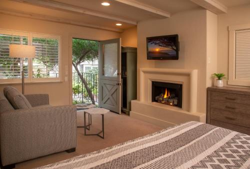 a bedroom with a bed and a fireplace at Carmel Country Inn in Carmel