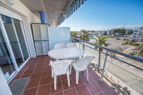 a table and chairs on a balcony with a view at Port Canigó 344 in Roses