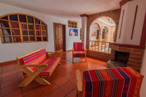 a living room with a chair and a fireplace at El Andariego in Otavalo
