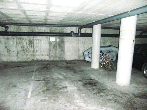 an empty parking garage with a car parked in it at Port Canigó 344 in Roses