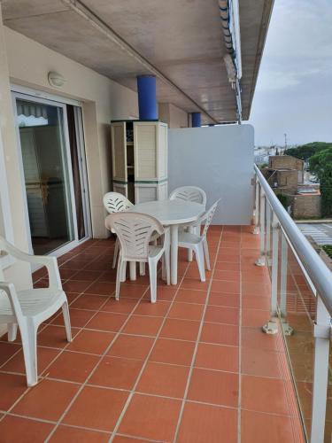 a balcony with a table and chairs on it at Port Canigó 344 in Roses