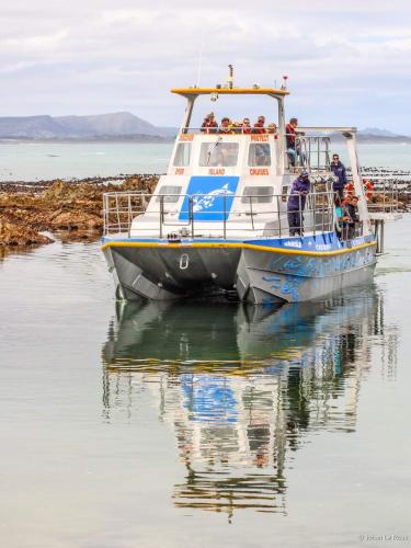 a group of people on a boat in the water at Villa Vue in Kleinbaai