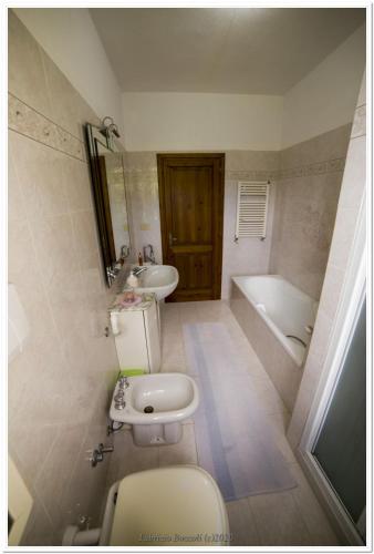 a bathroom with a toilet and a sink and a tub at Casa Nanni in Portoferraio
