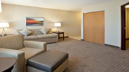 a living room with a couch and a table at Holiday Inn Express Hotel & Suites Minneapolis - Minnetonka, an IHG Hotel in Minnetonka