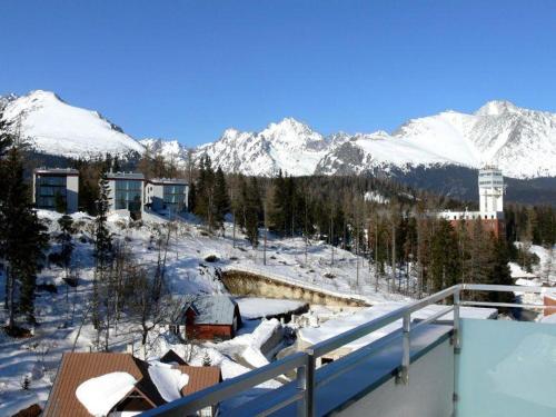 a balcony with snow covered mountains in the background at Apartman Panorama 805 in Štrbské Pleso