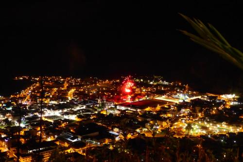 a view of a city at night with lights at La Casa Amarilla in Baños