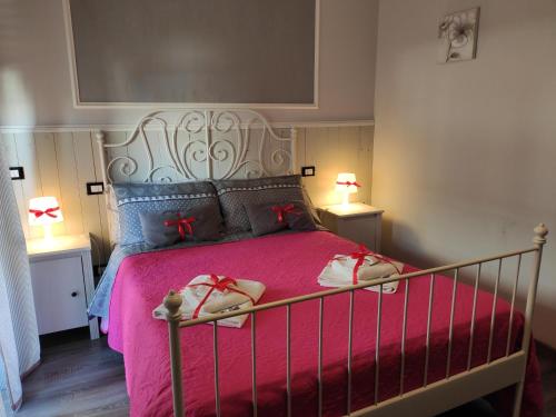 a bedroom with a large bed with pink sheets and pillows at Sweet Rome B&B in Rome