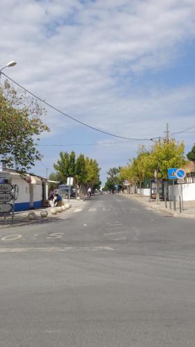 an empty street in a town with a blue sky at Casa Férias Melides in Melides
