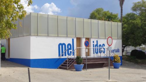 a large building with a sign on the side of it at Casa Férias Melides in Melides