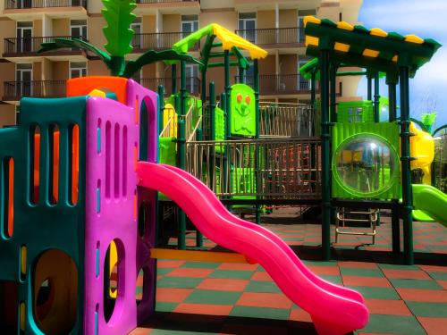 a playground with a slide in front of a building at BH Mangrove Condos in Mactan