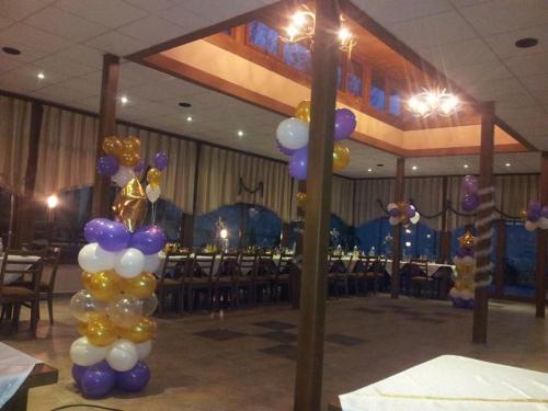 a bunch of balloons in a room with a table at Hotel Tsarevets in Asenovgrad