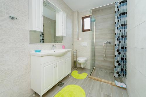 a bathroom with a sink and a shower and a toilet at Vila Fortuna in Sutomore