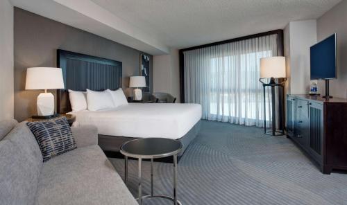 a hotel room with a bed and a couch at Hyatt Regency San Francisco Airport in Burlingame