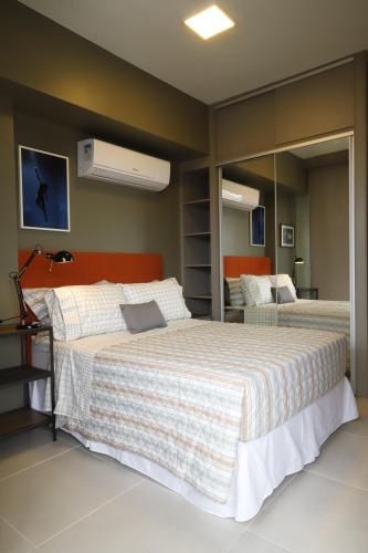 1 dormitorio con 1 cama grande y espejo en #1 Sofisticado Estúdio na Boaventura da Silva en Belém
