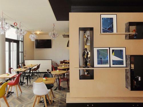 a restaurant with tables and chairs in a room at Ibis Budget Annecy sud-Poisy in Poisy