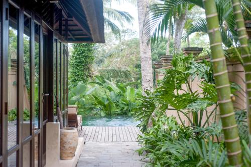 a pool in the middle of a house with plants at Komaneka at Tanggayuda Ubud in Ubud