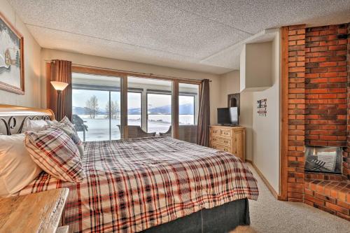 a bedroom with a bed and a large window at Mtn Views and Hot Tub Access Lake Dillon Retreat in Dillon