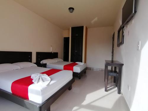 Postel nebo postele na pokoji v ubytování Hotel Portal Dorado
