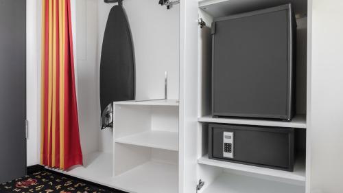 a living room with a tv and a curtain at Holiday Inn Munich - Westpark by IHG in Munich