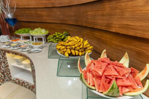 a buffet of fruits and vegetables on a table at Hotel Essencia in Dumaguete