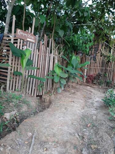 a wooden fence with green plants on it at Xingú Camping Site in Leticia