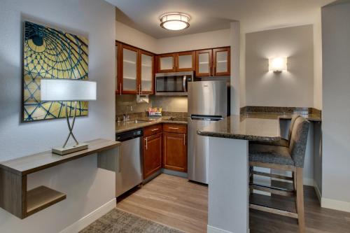 a kitchen with a counter and a refrigerator at Staybridge Suites Missoula by IHG in Missoula
