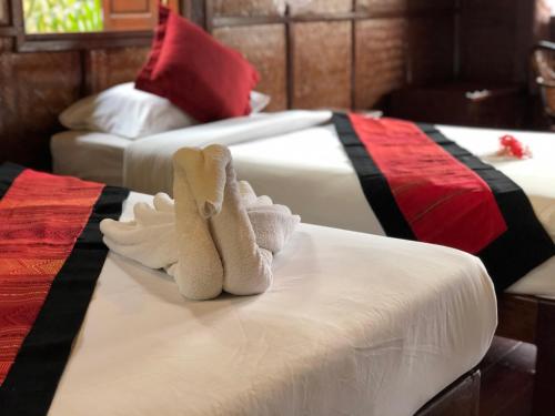Voodi või voodid majutusasutuse Mekong Riverside Lodge toas