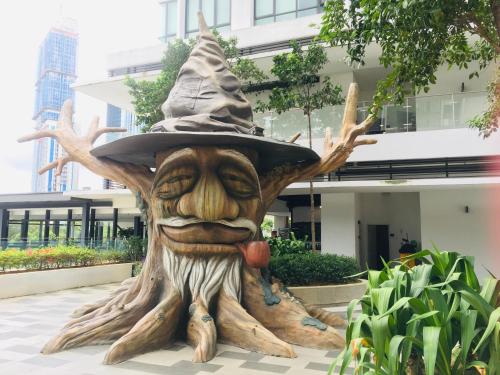 a statue of a tree stump wearing a hat at Studio I-Soho D'Gunduls Homestay by DGH I-CITY in Shah Alam