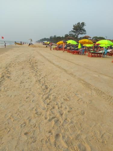 a beach with many tables and umbrellas on it at Villa Mayfair in Cavelossim