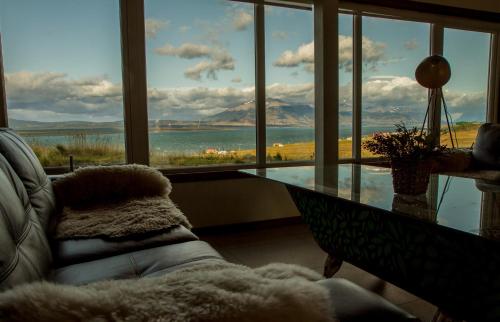 a living room with a glass table and a large window at Best Western Patagonia in Puerto Natales