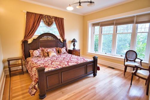 a bedroom with a large bed and windows at Regal Victorian Home in Downtown Calistoga in Calistoga