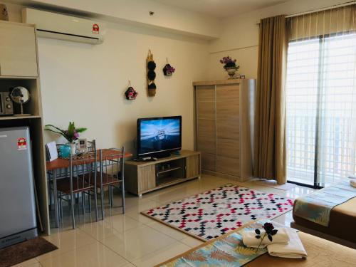a living room with a flat screen tv and a living room at Studio I-Soho D'Gunduls Homestay by DGH I-CITY in Shah Alam