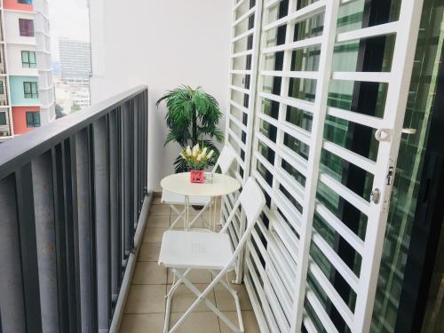 a balcony with a table and a plant at Studio I-Soho D'Gunduls Homestay by DGH I-CITY in Shah Alam