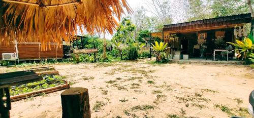 a dirt yard in front of a building at Kohmook Nurse House in Koh Mook