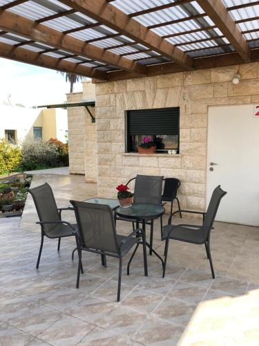 a patio with a table and chairs on a patio at צימר בעמק in Kefar Ruppin