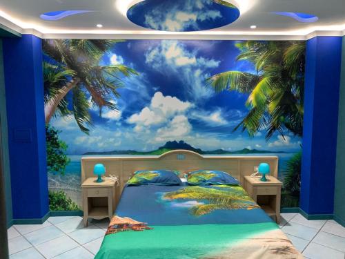 a bedroom mural of a beach with palm trees at Hotel Blanc in Casoria