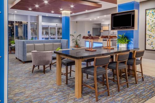 a conference room with a table and chairs and a tv at Holiday Inn Express & Suites - Rice Lake by IHG in Rice Lake