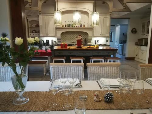 a kitchen with a table with a vase of flowers on it at Ikamu's lodge in Germiston