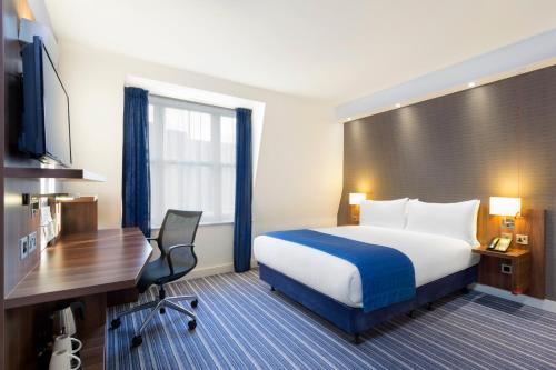 a hotel room with a bed and a desk at Holiday Inn Express Southwark by IHG in London