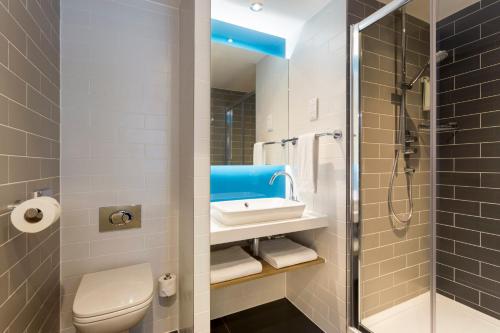 a bathroom with a toilet and a sink and a shower at Holiday Inn Express Southwark, an IHG Hotel in London