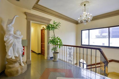 a staircase in a house with a statue of a woman at The Spring Hotel in Ho Chi Minh City