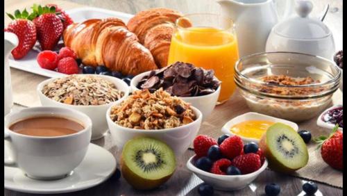 a breakfast table with breakfast foods and fruit on a table at La Casa di Isabella Loreto in Loreto